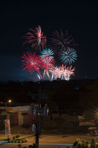 Low angle view of firework display at night
