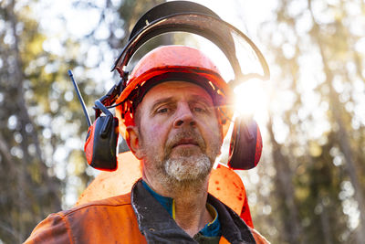 Portrait of mature male lumberjack at work