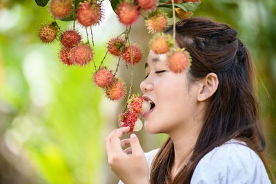 Portrait of young woman with plants