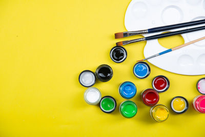 High angle view of multi colored pencils on yellow table