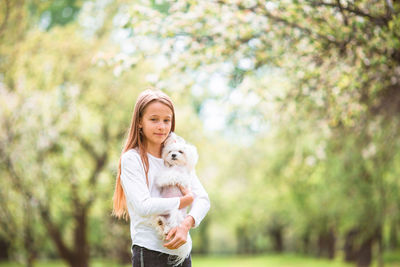 Portrait of a smiling young woman with dog