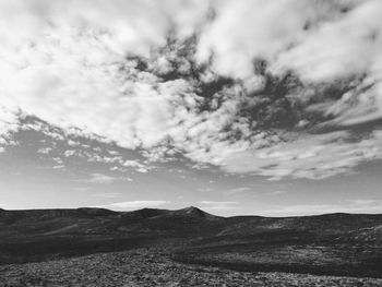 Scenic view of landscape against cloudy sky