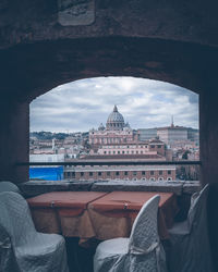 St peters basilica and buildings seen through restaurant building