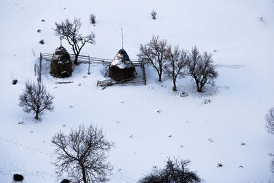 High angle view of bare trees on snow field during winter