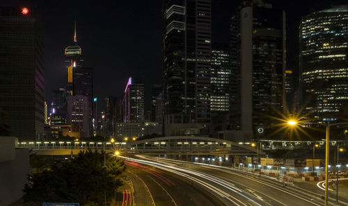 Illuminated city street and buildings at night