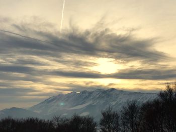 Scenic view of snowcapped mountains against sky during sunset