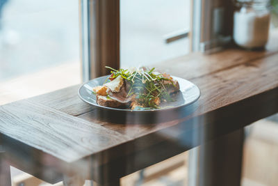 Sandwich served on plate on table