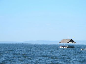 Scenic view of calm sea against clear sky