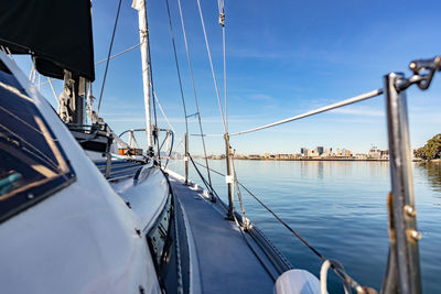 Sailboats moored in sea against sky