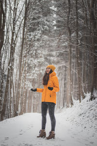 Woman standing on snow covered land