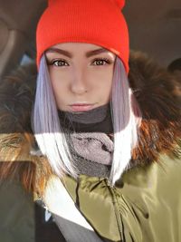Portrait of young woman in hat during winter