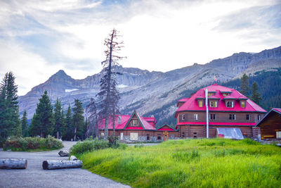 Scenic view of house and mountains against sky