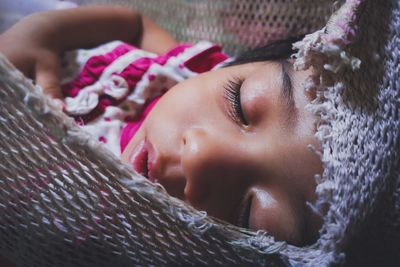 Cute baby girl sleeping on bed