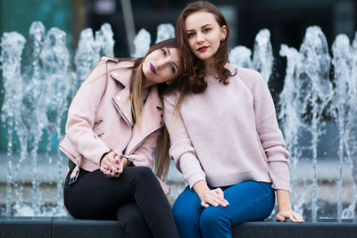 Portrait of smiling friends sitting outdoors