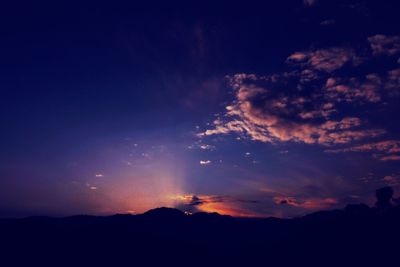 Low angle view of silhouette mountain against sky at sunset