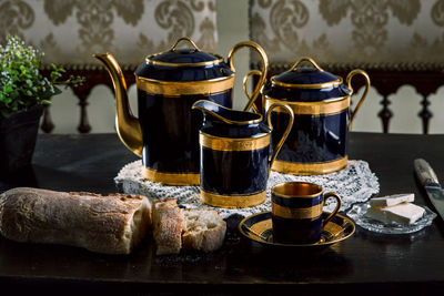 Tea kettles and breads on table