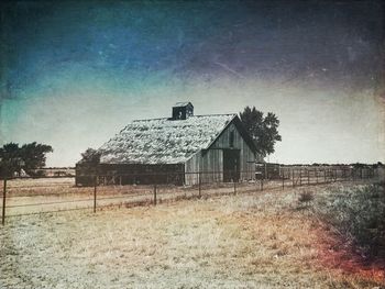 Abandoned house on field against sky