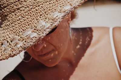 Close-up of woman wearing hat during sunny day