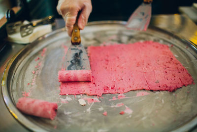 Cropped hand of person preparing ice cream