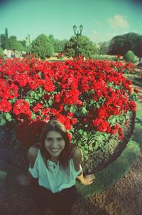 Portrait of smiling girl with flowers on plants