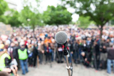 Close-up of microphone against crowd