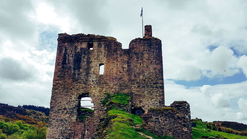 Low angle view of historic building against cloudy sky