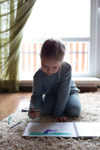 Boy drawing at home