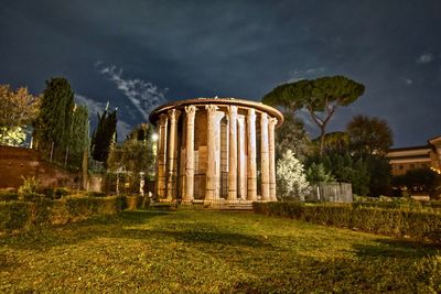 Old ruin building on field against sky