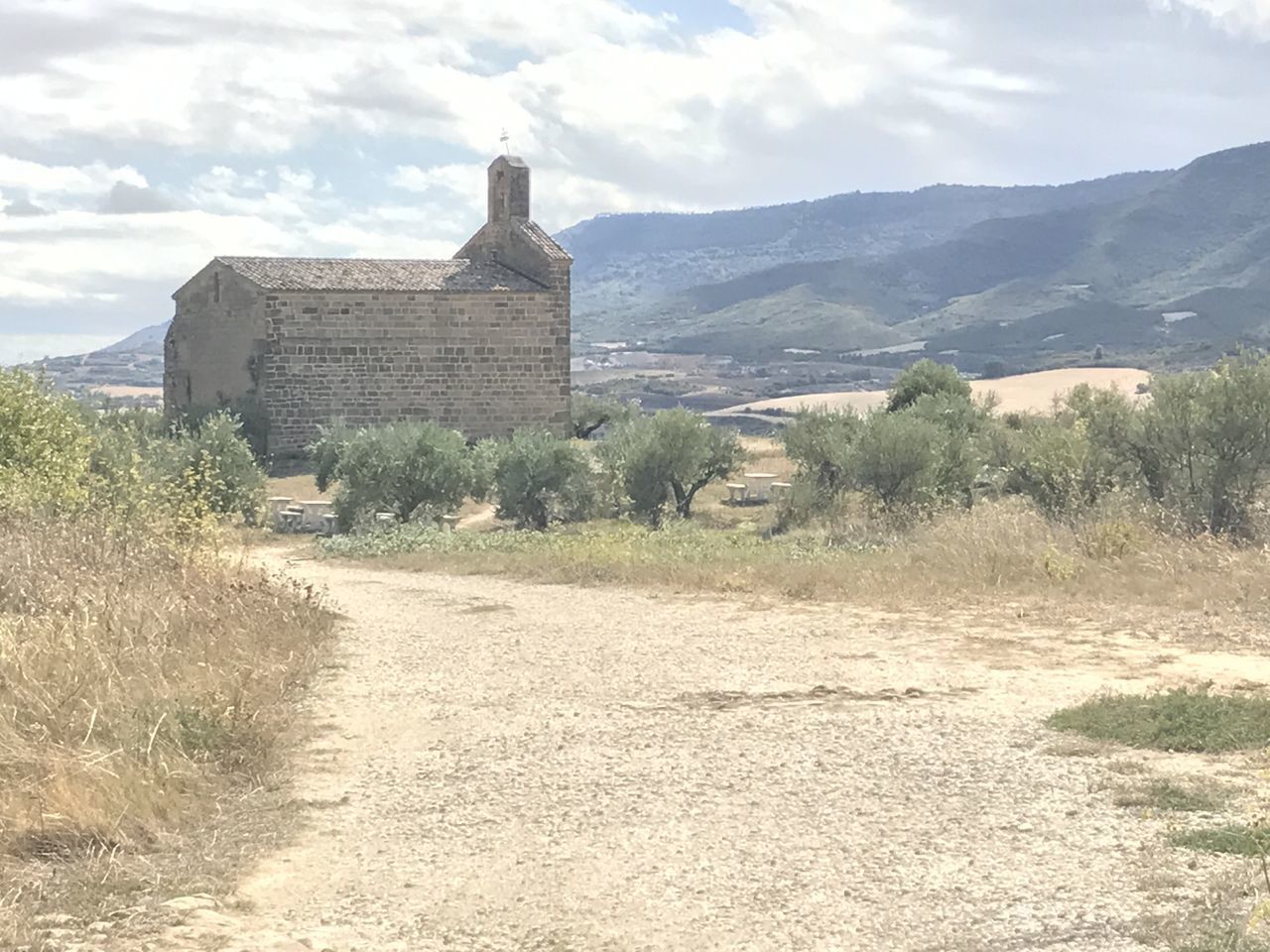 BUILDINGS BY MOUNTAIN AGAINST SKY