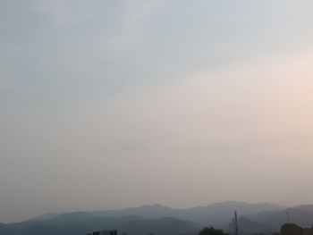 Scenic view of silhouette mountains against sky during sunset