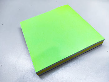 High angle view of green paper against white background