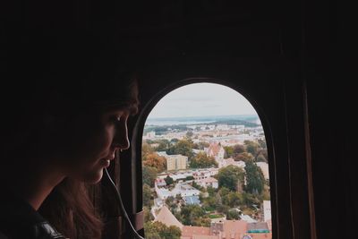 Woman sitting by airplane window