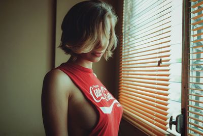 Close-up of young woman standing at home