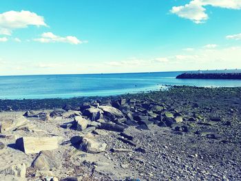 Scenic view of sea against cloudy sky