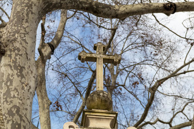 Low angle view of cross in cemetery