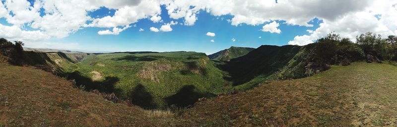 Panoramic shot of land and trees against sky