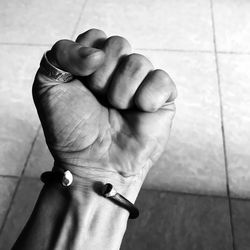 Close-up of person hand on tiled floor