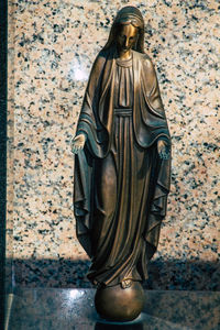 Statue of buddha against wall