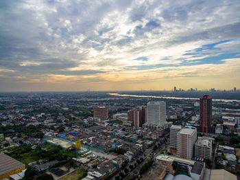 High angle view of city buildings against sky during sunset