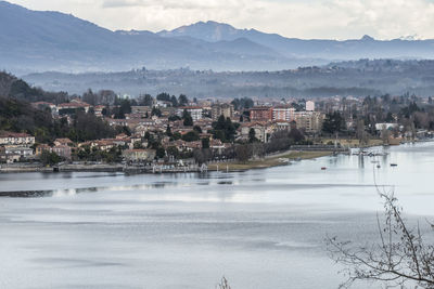 Scenic view of lake by mountains against sky