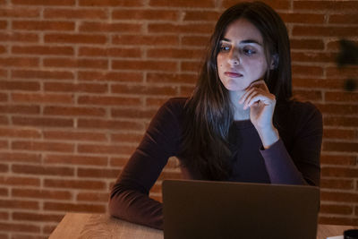 Young woman using laptop at home