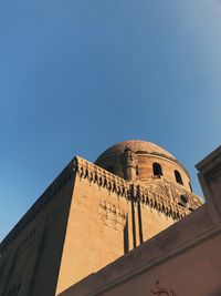 Low angle view of traditional building against clear blue sky