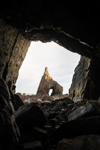 Low angle view of rock formation against sky