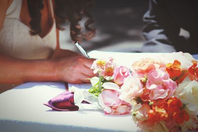 Close-up of cropped hand holding flower