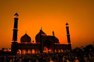 Group of people in front of building during sunset