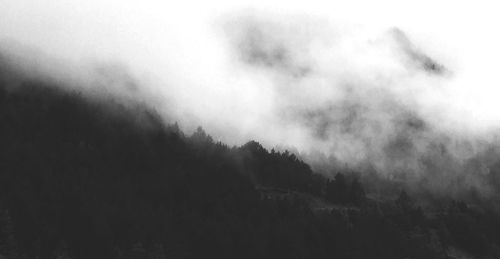 Scenic view of mountains in foggy weather