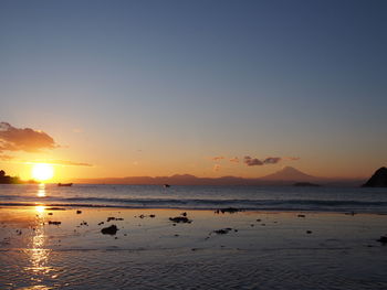 Scenic view of sea against clear sky during sunset