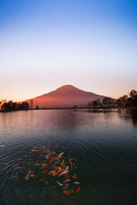 Scenic view of lake against sky during sunset