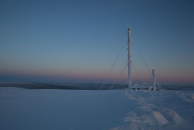 Snow covered sailboat against sky