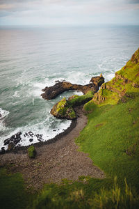 Scenic view of rocks on beach against sky